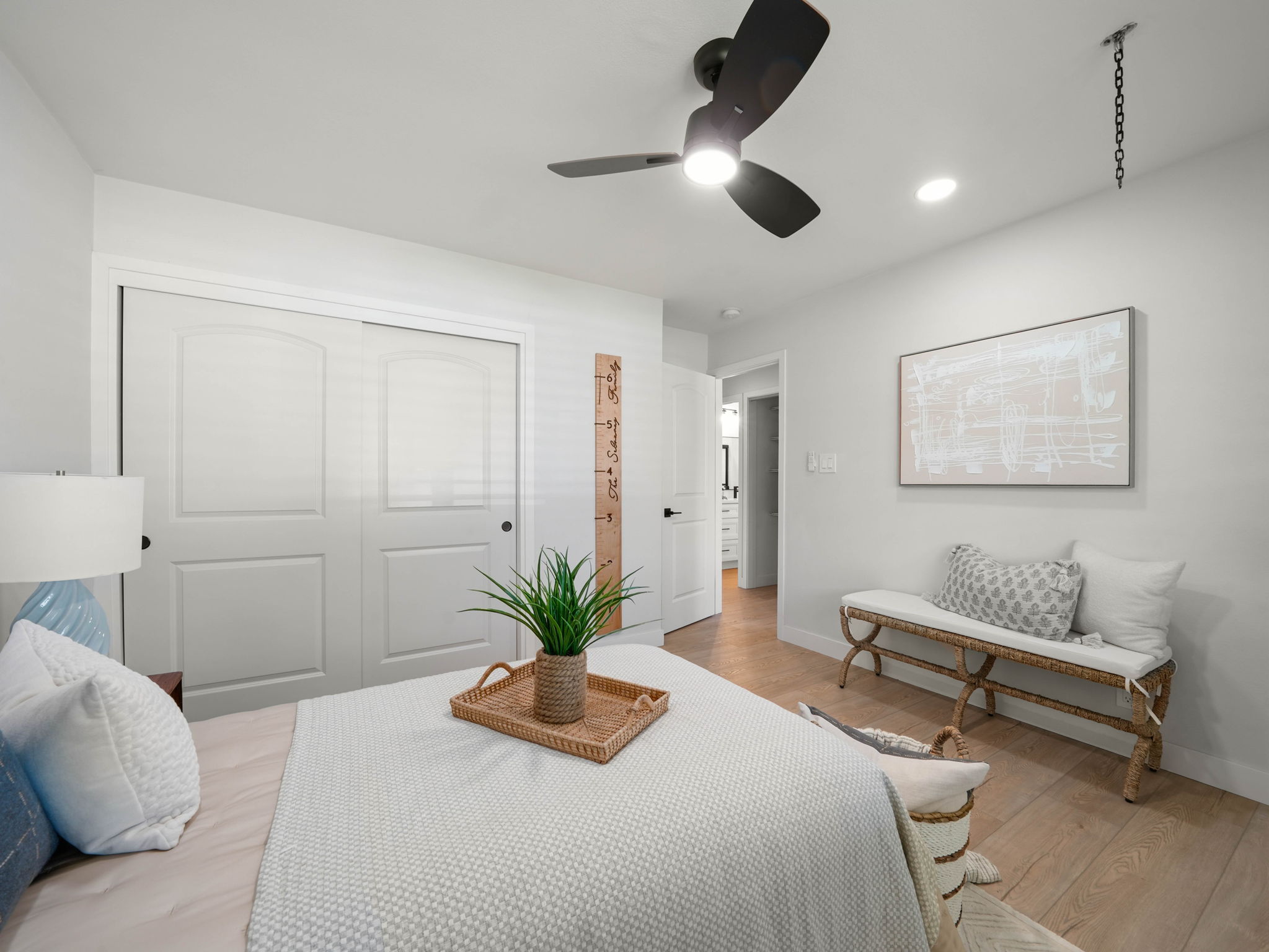 Primary bedroom with closet and bench seating