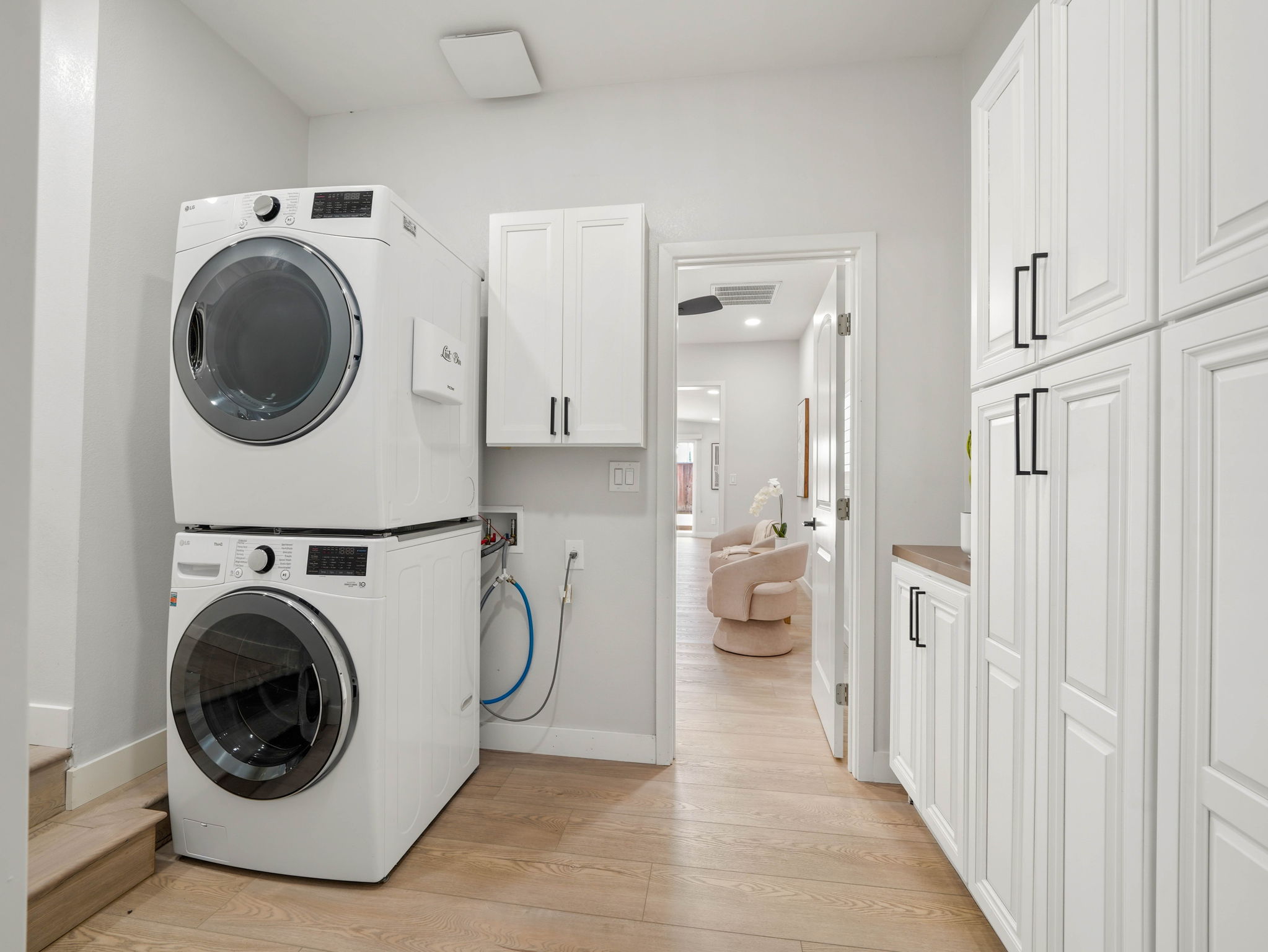 Utility room with stacked LG washer and dryer