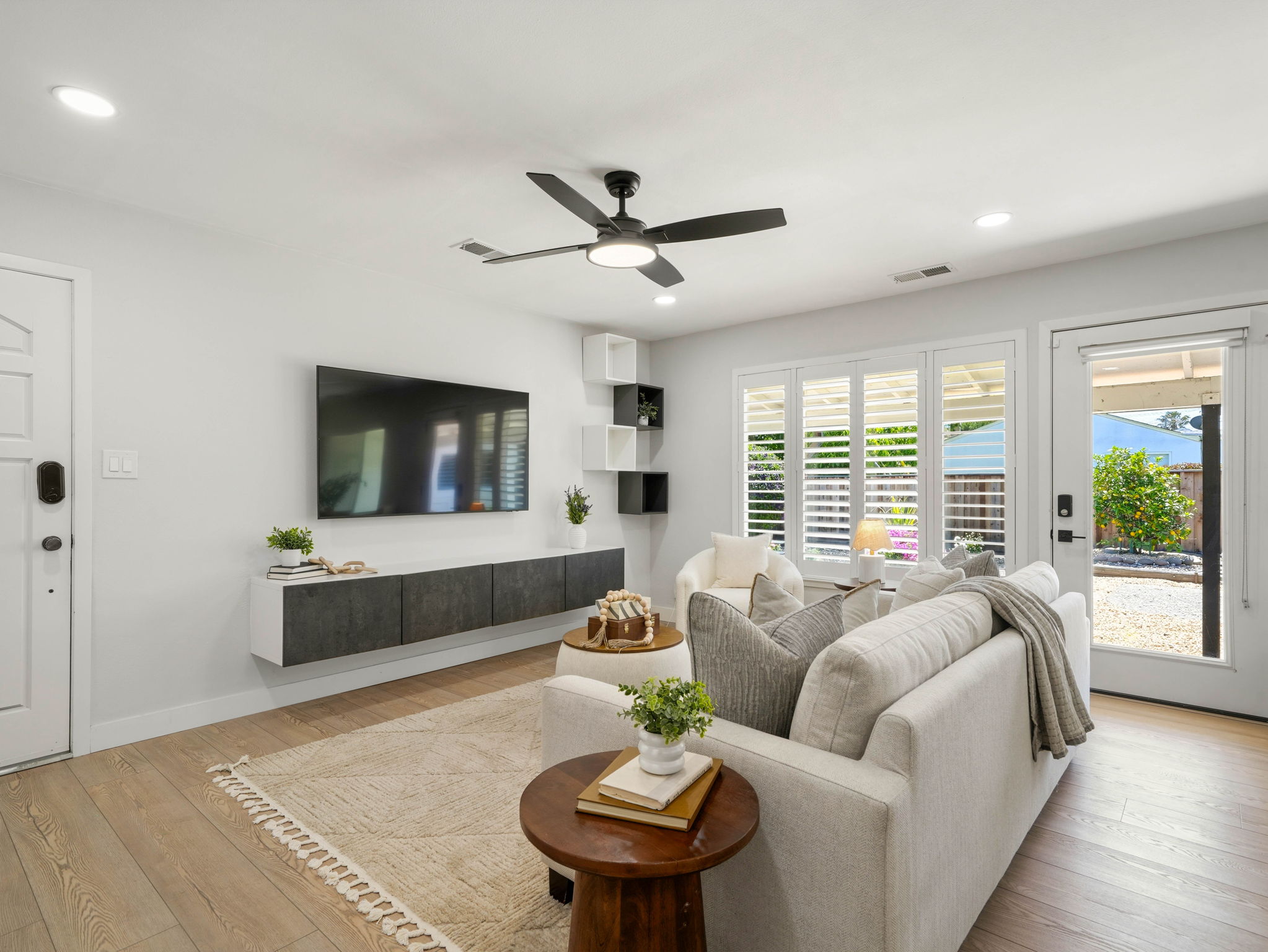 Open-concept living room with natural light and smart TV