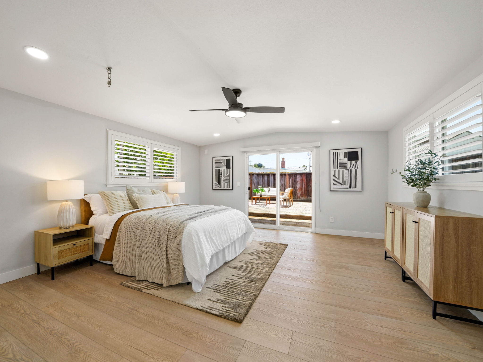 Expansive primary bedroom with vaulted ceiling